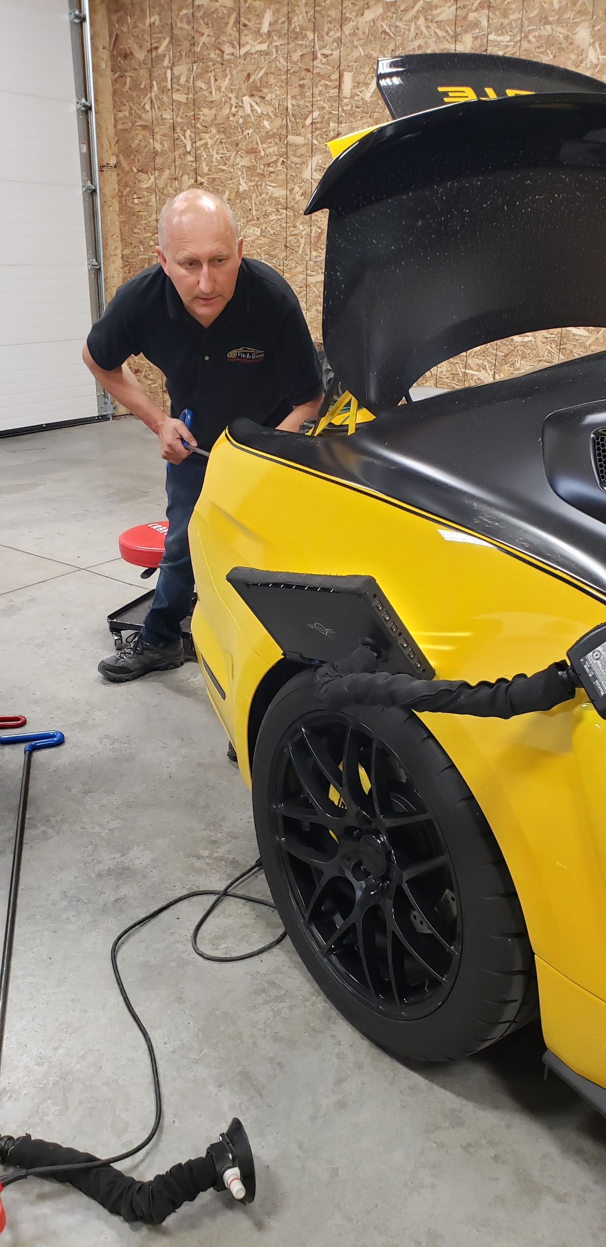 Alex Hivrenko working on paintless dent repair in the FixADent shop
