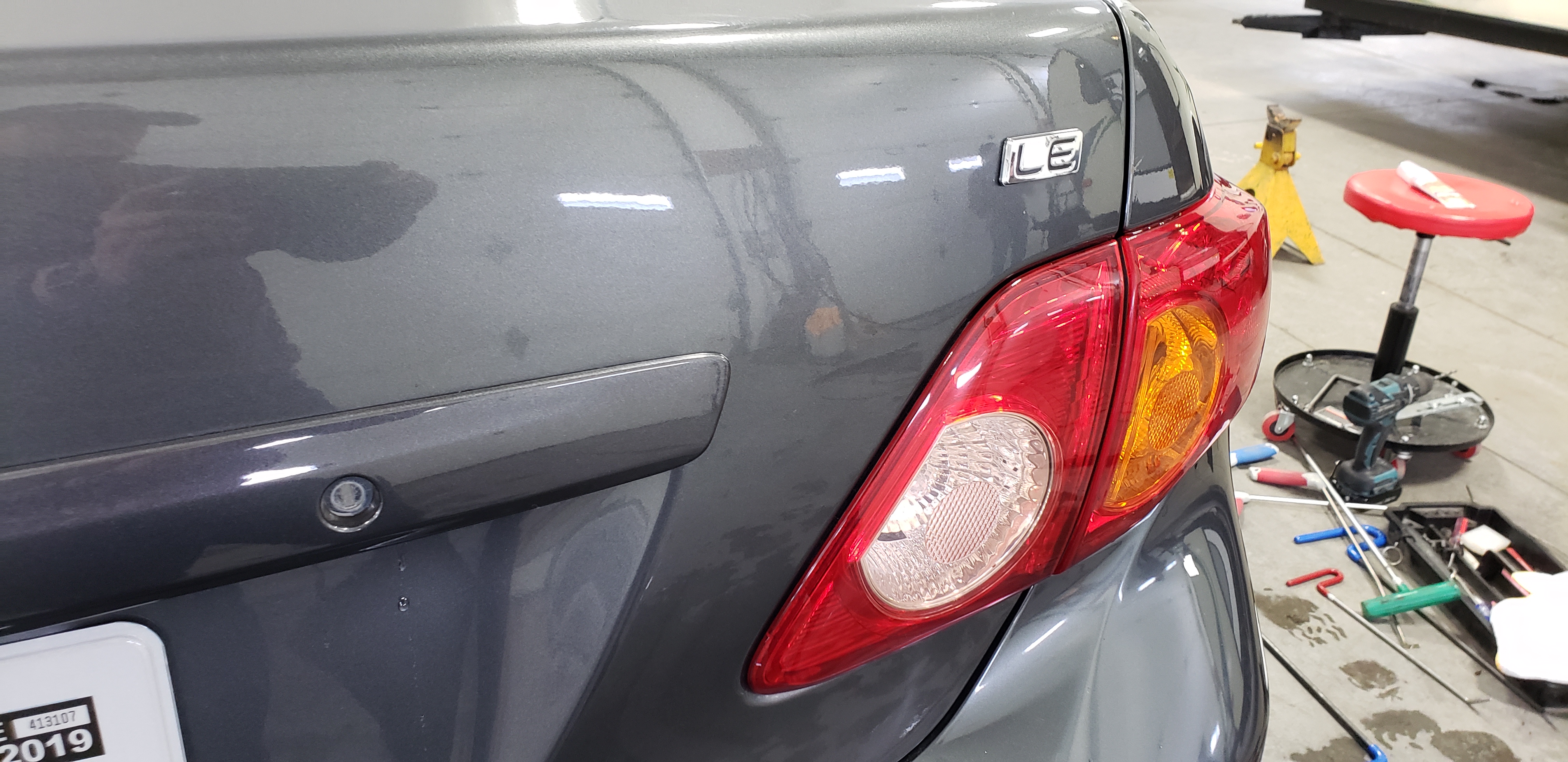 Dark front fender after paintless dent repair