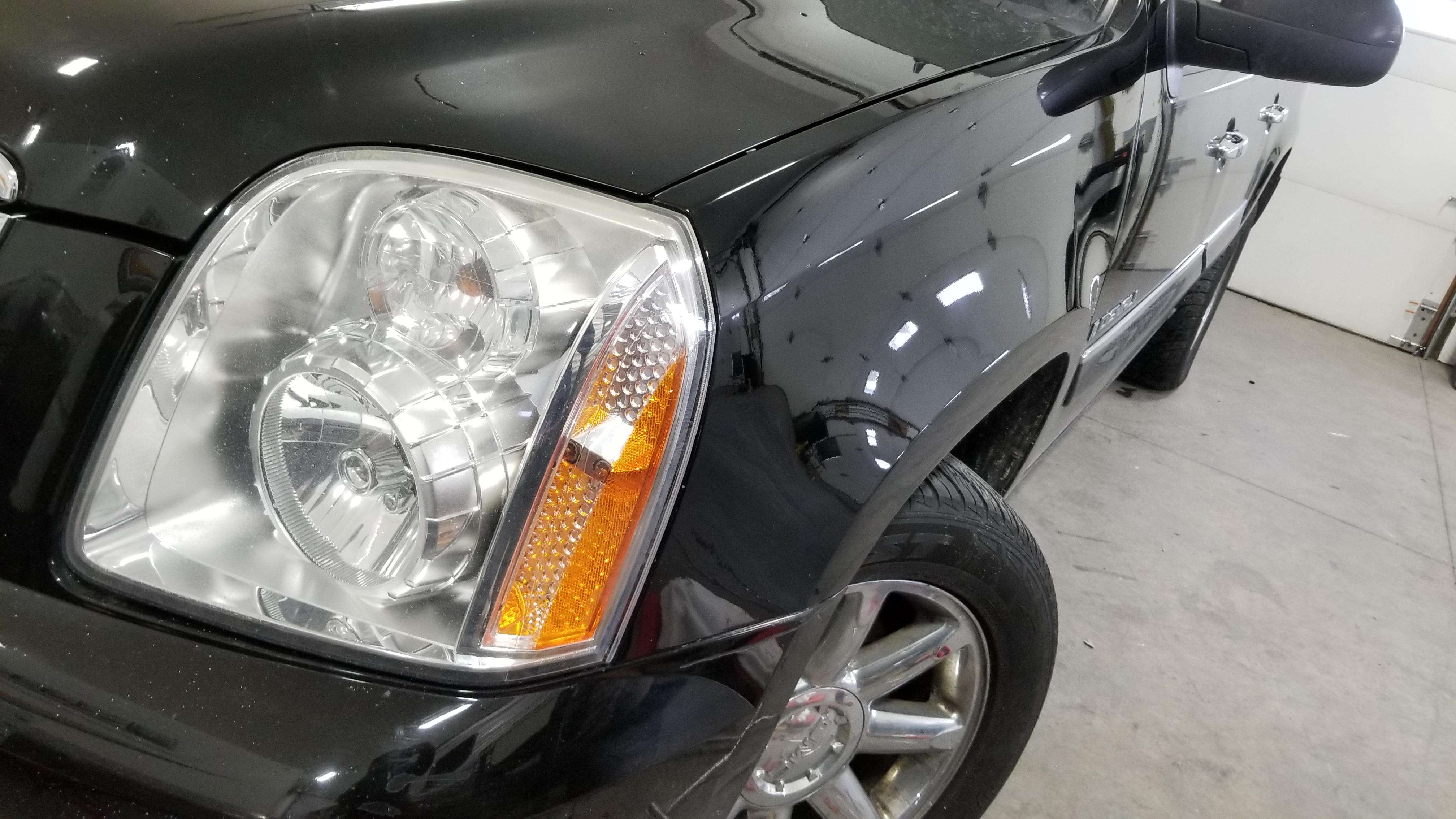 Black SUV front fender after paintless dent repair