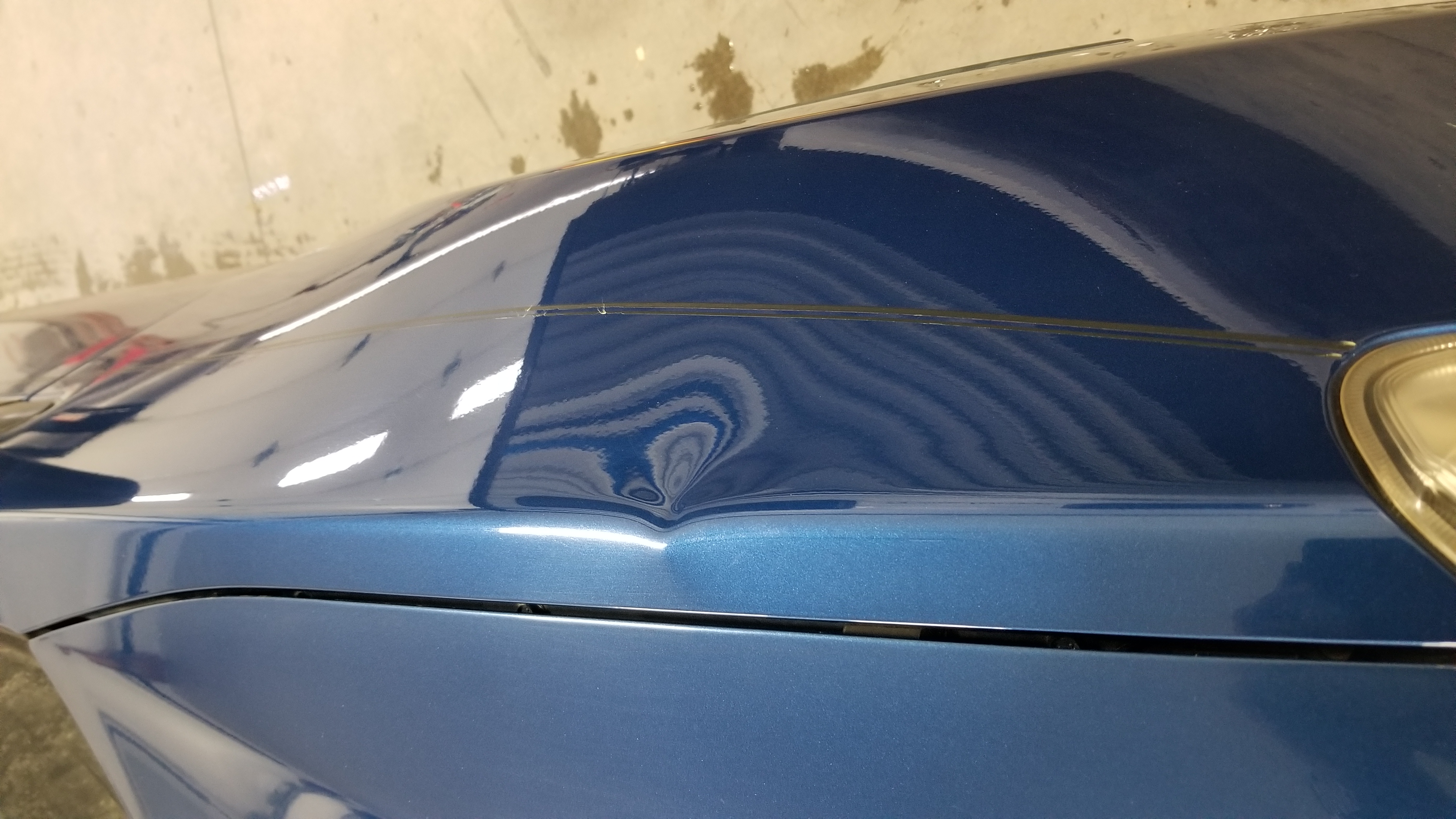 Blue hood before paintless dent repair
