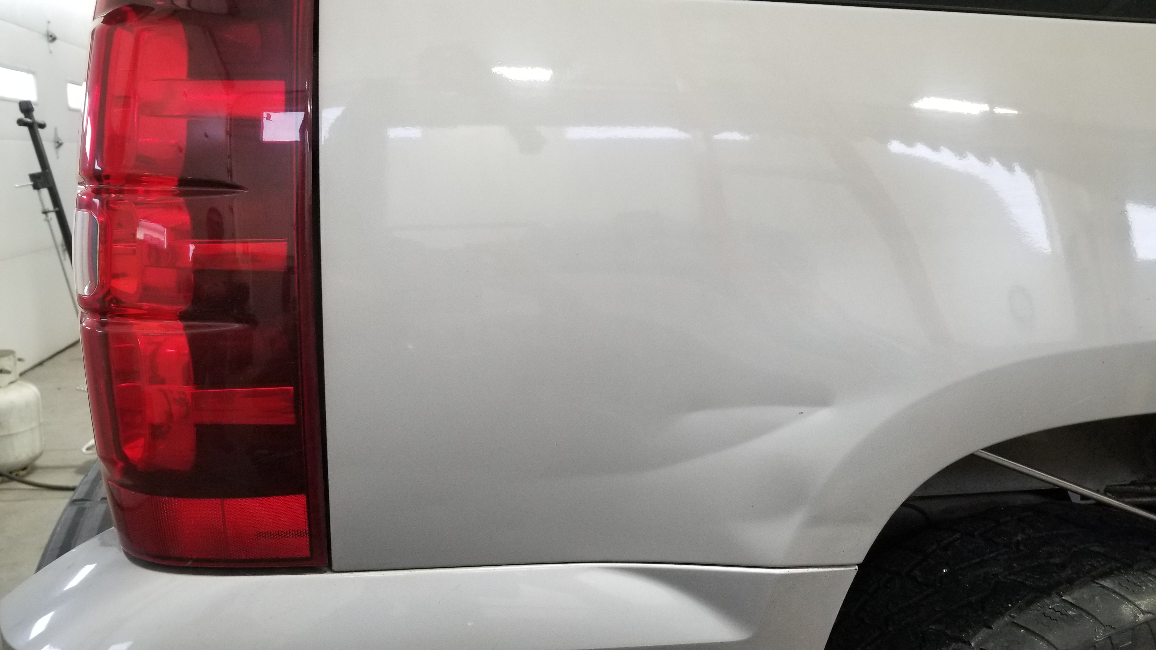 Blue truck fender before paintless dent repair