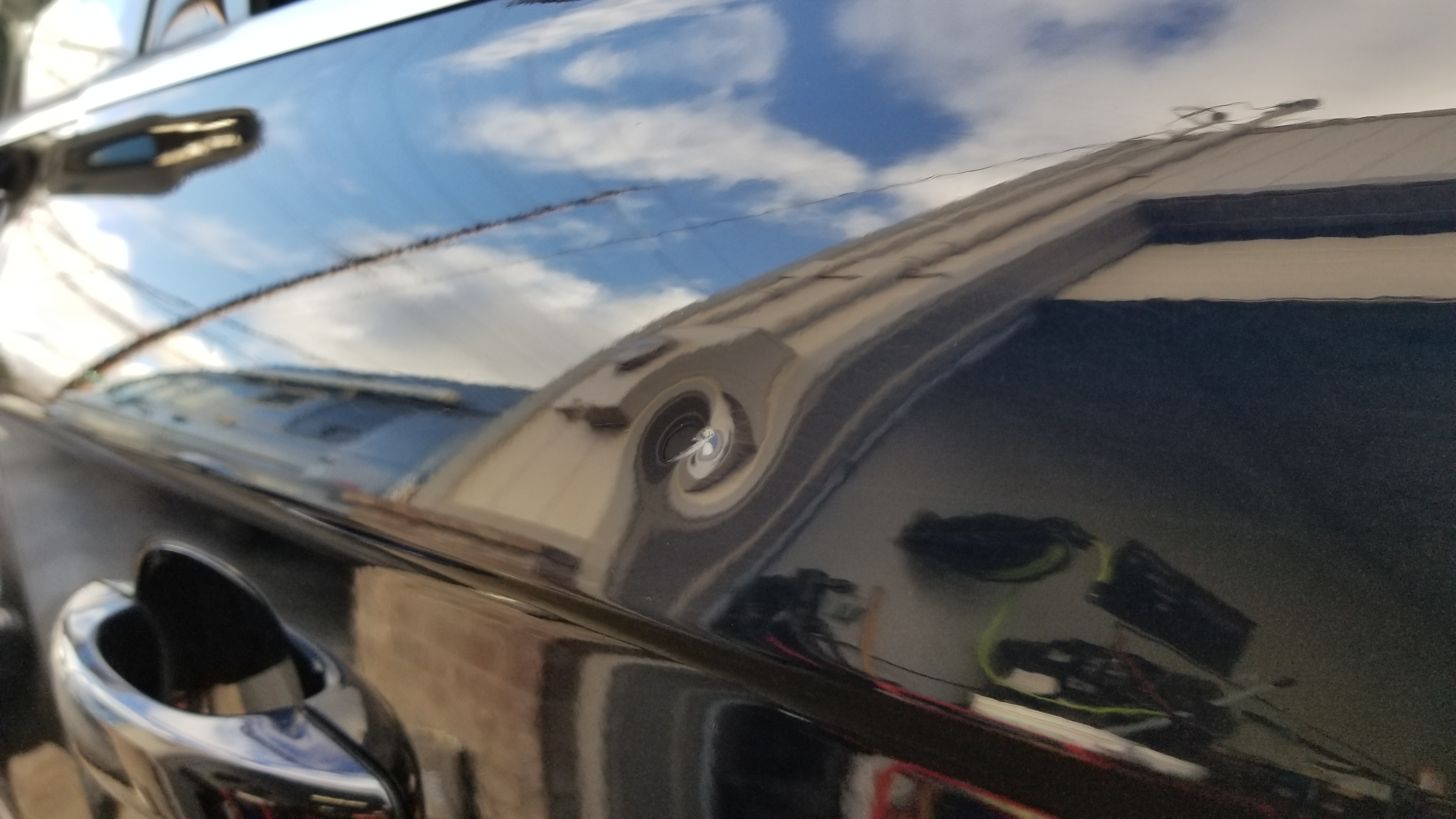 Dark vehicle door before paintless dent repair