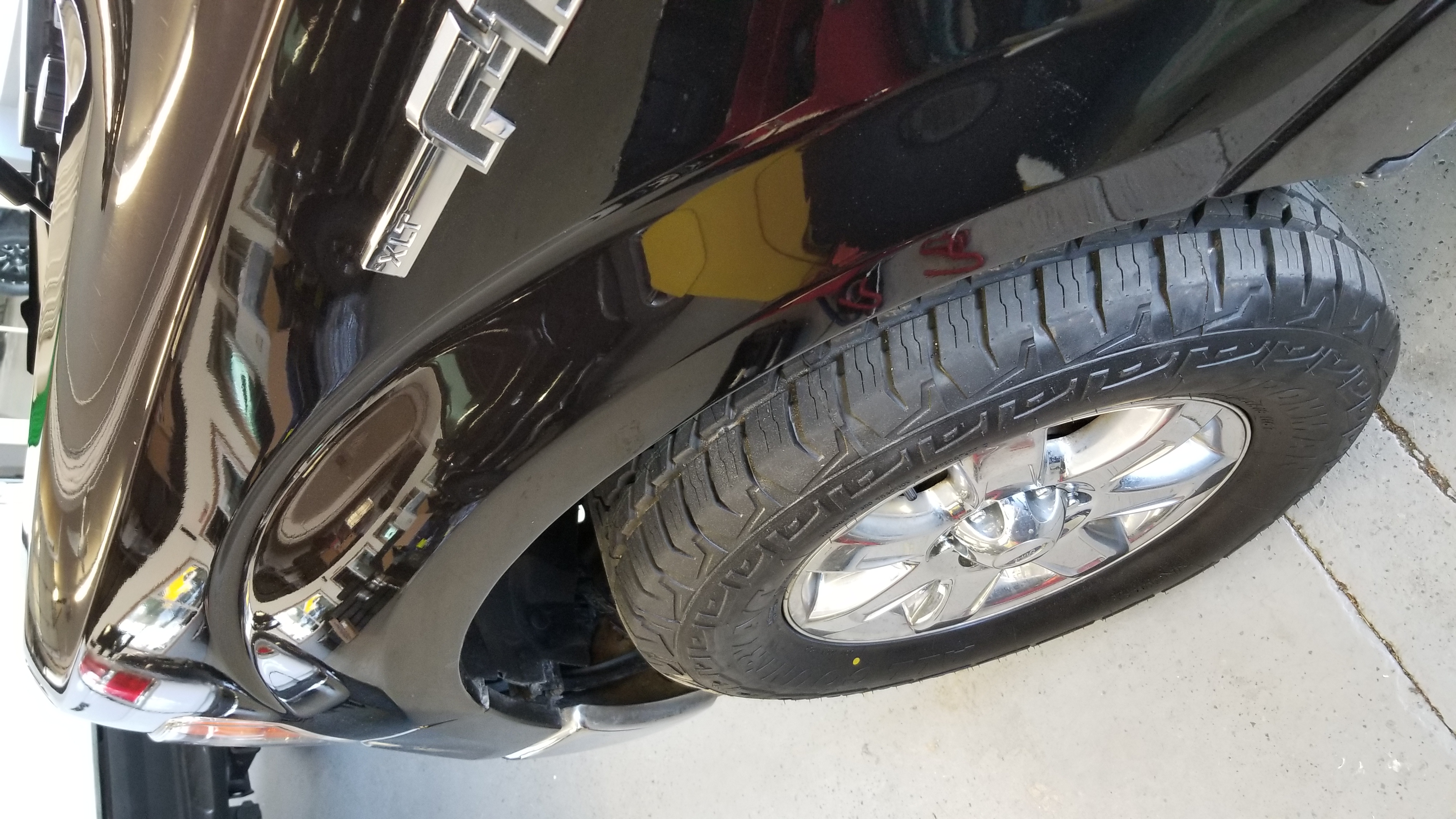 Black truck fender after paintless dent repair