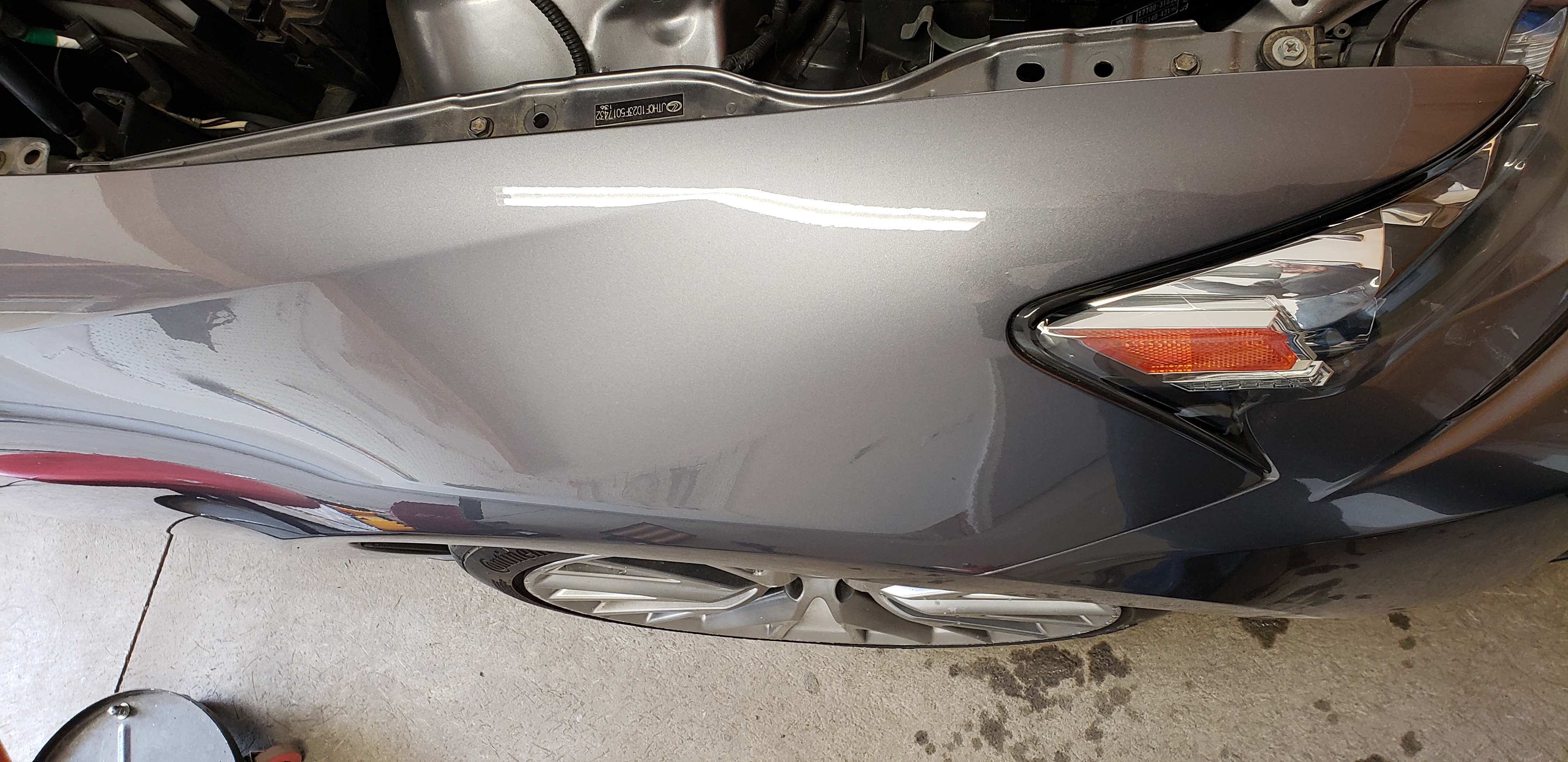 Gray front fender after paintless dent repair