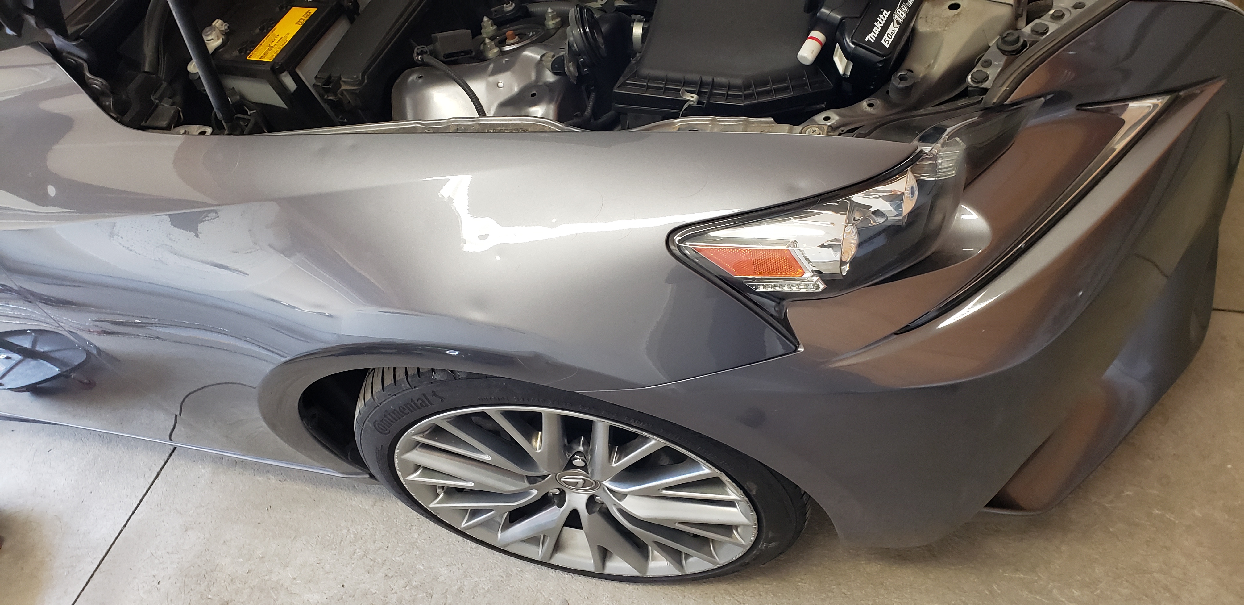 Gray front fender before paintless dent repair