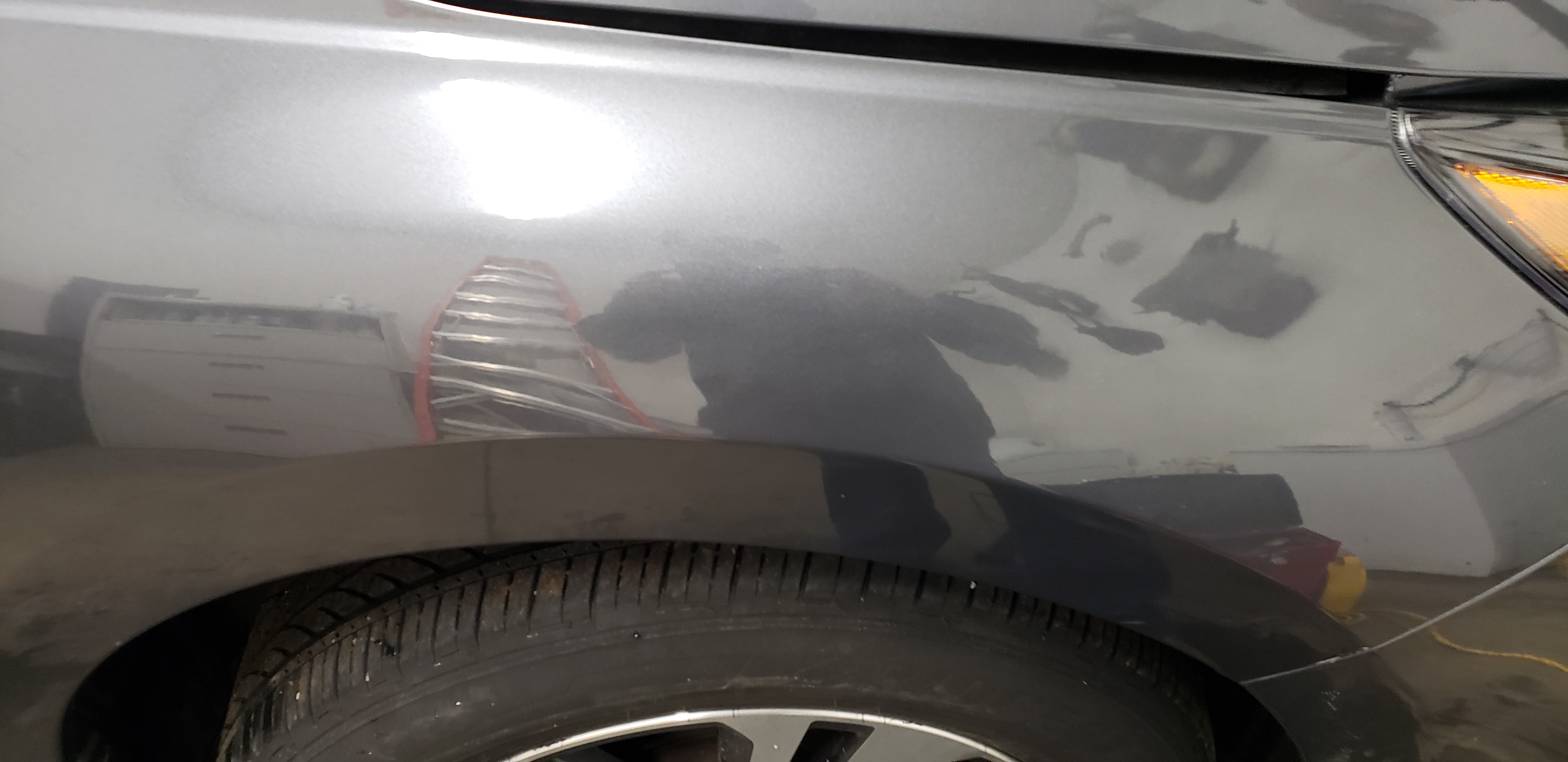 Gray front fender after paintless dent repair