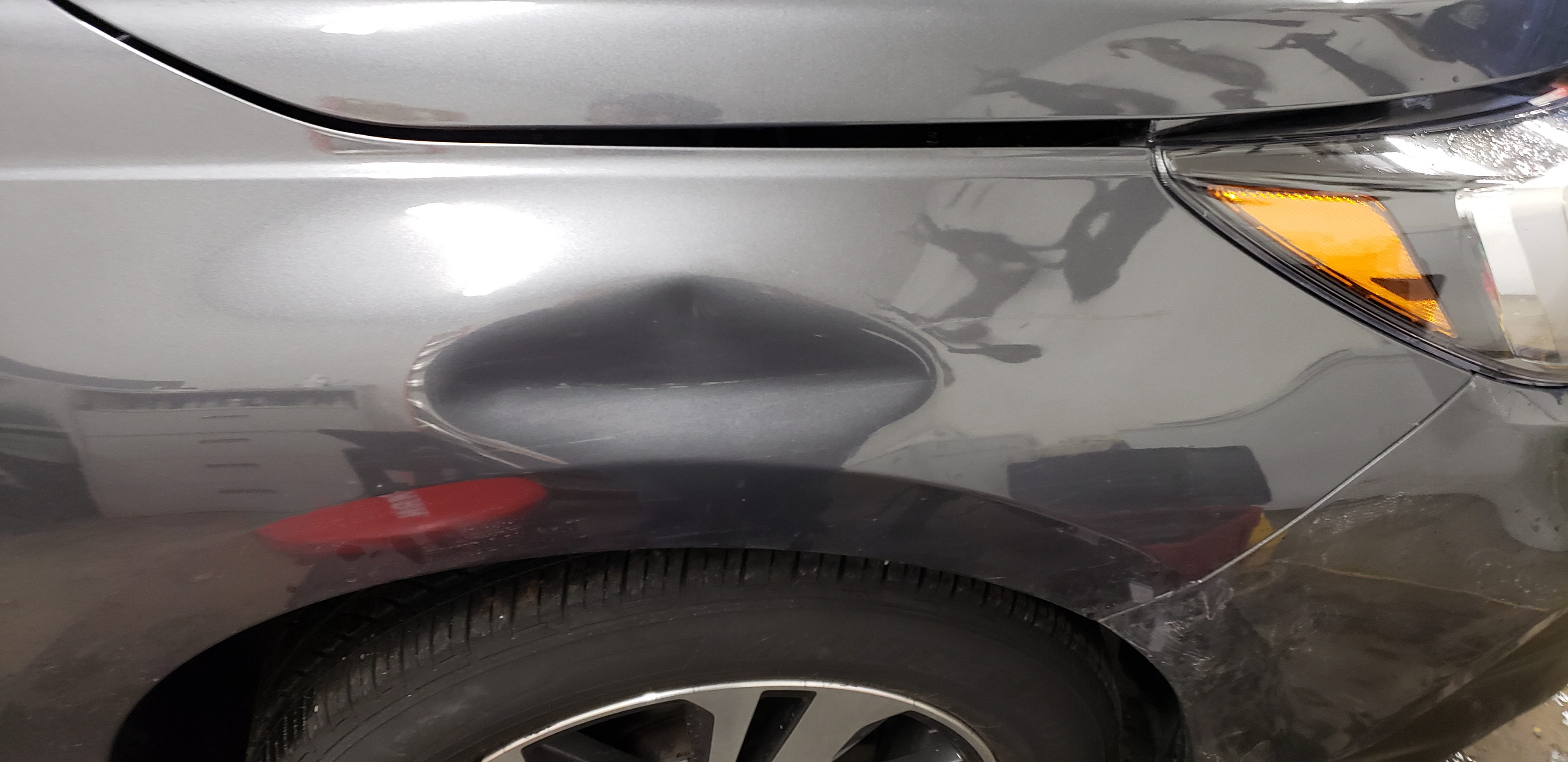 Gray front fender before paintless dent repair