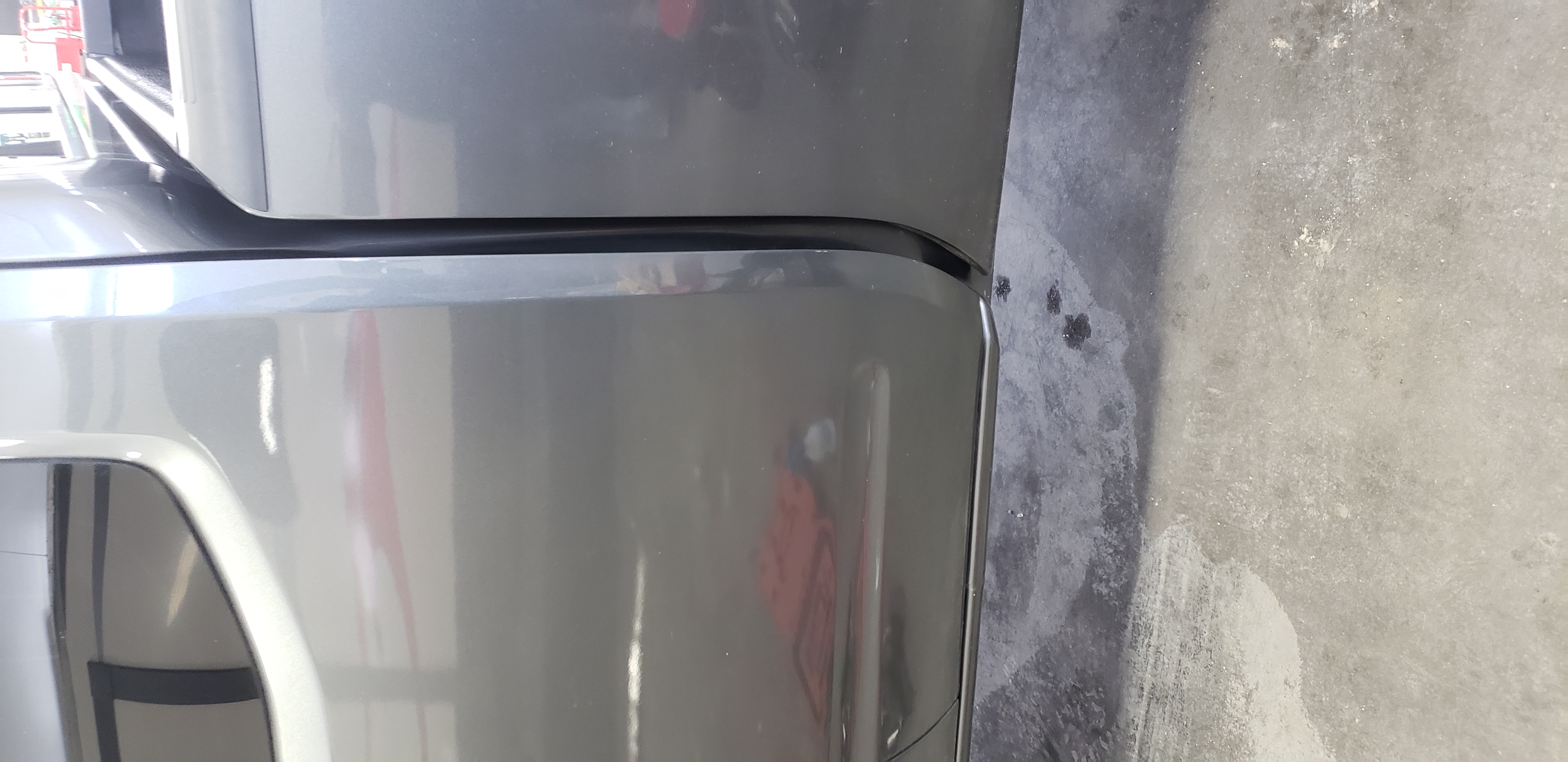 Gray quarter panel after paintless dent repair