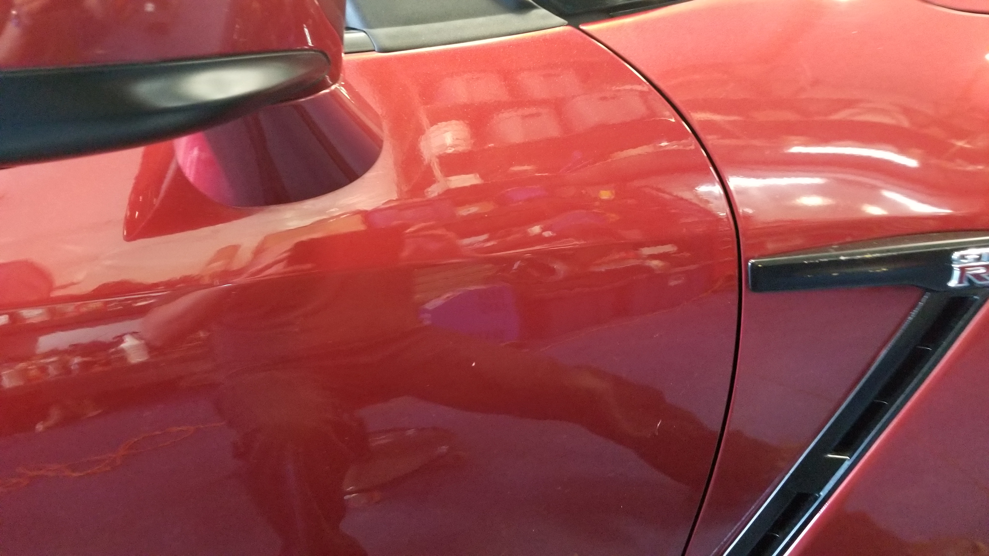 Red GT-R door after paintless dent repair