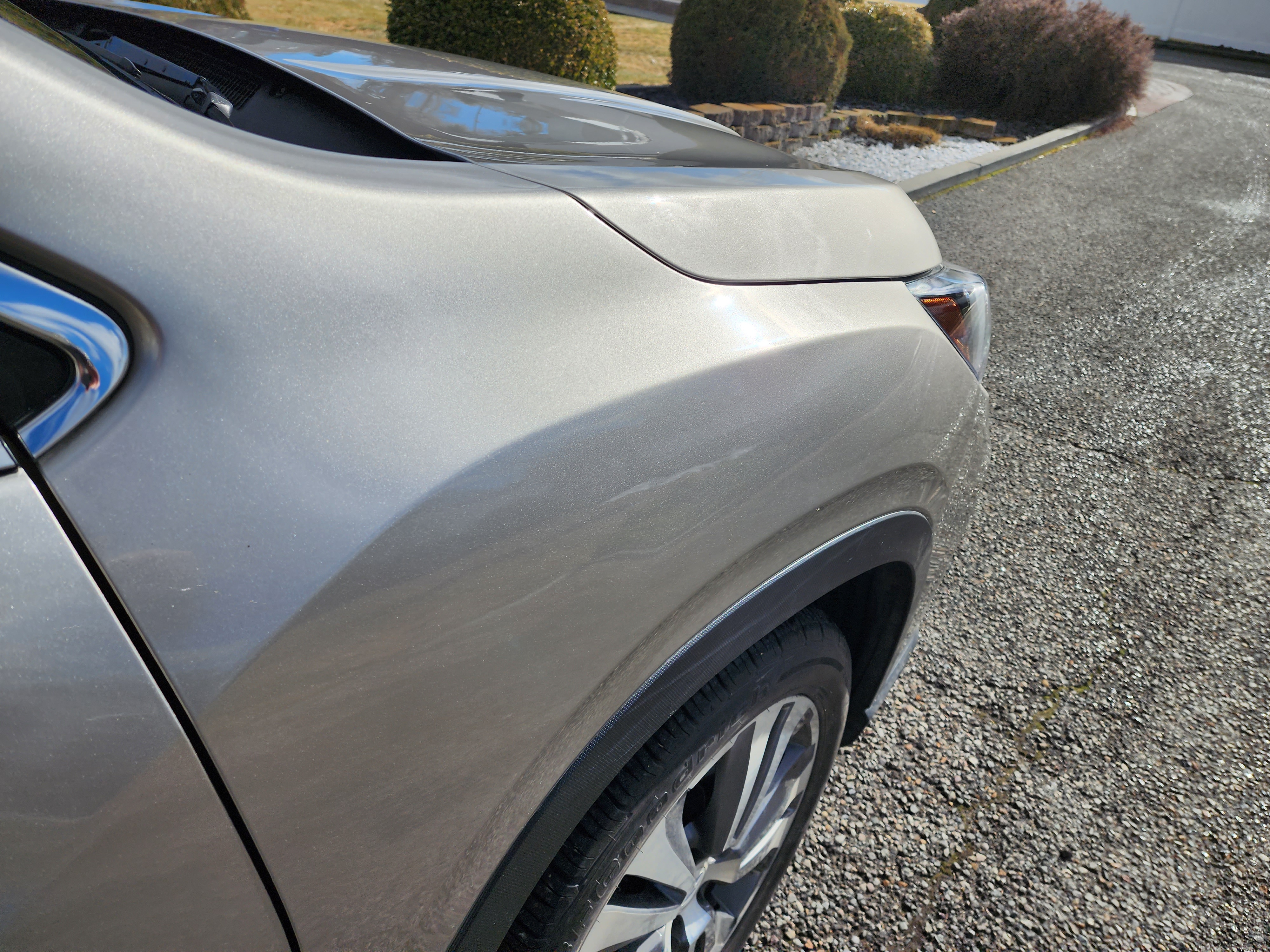 Tan front fender after paintless dent repair