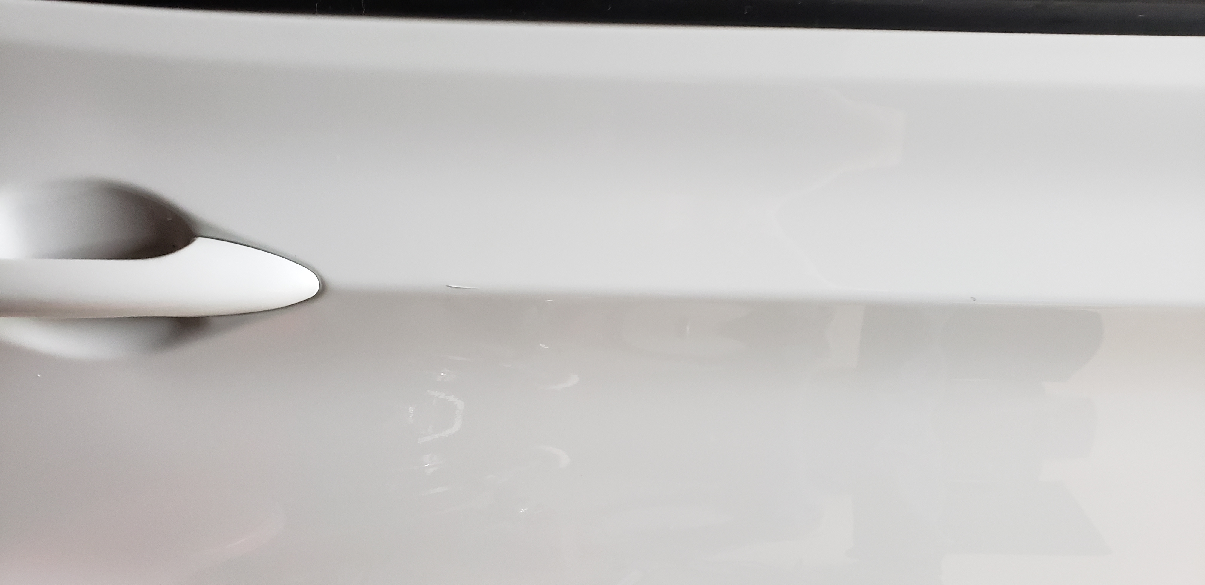 White door after paintless dent repair