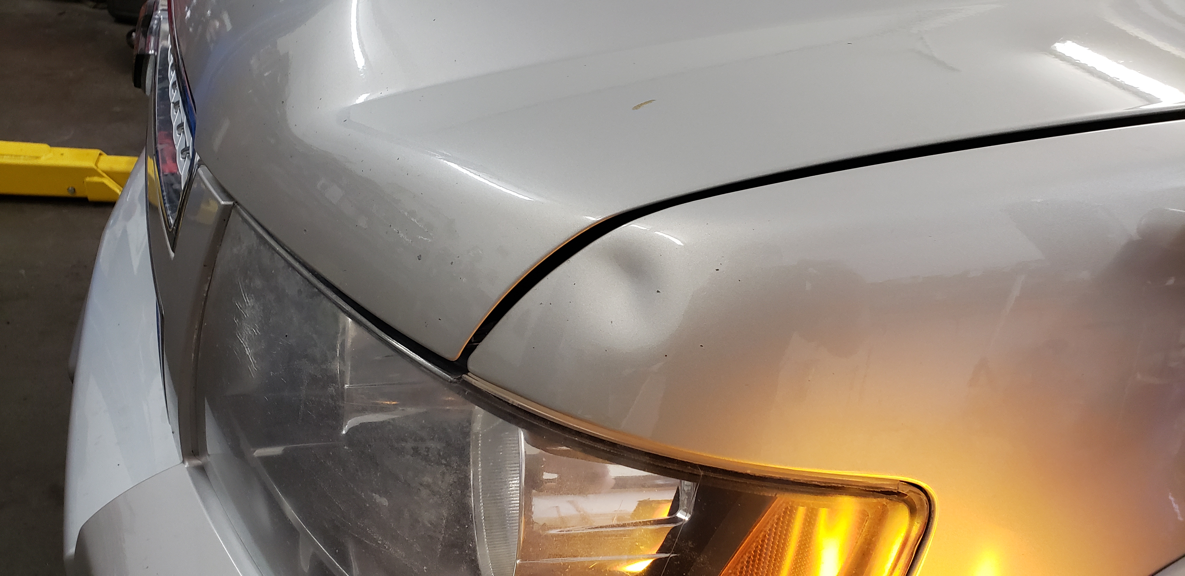 White hood before paintless dent repair