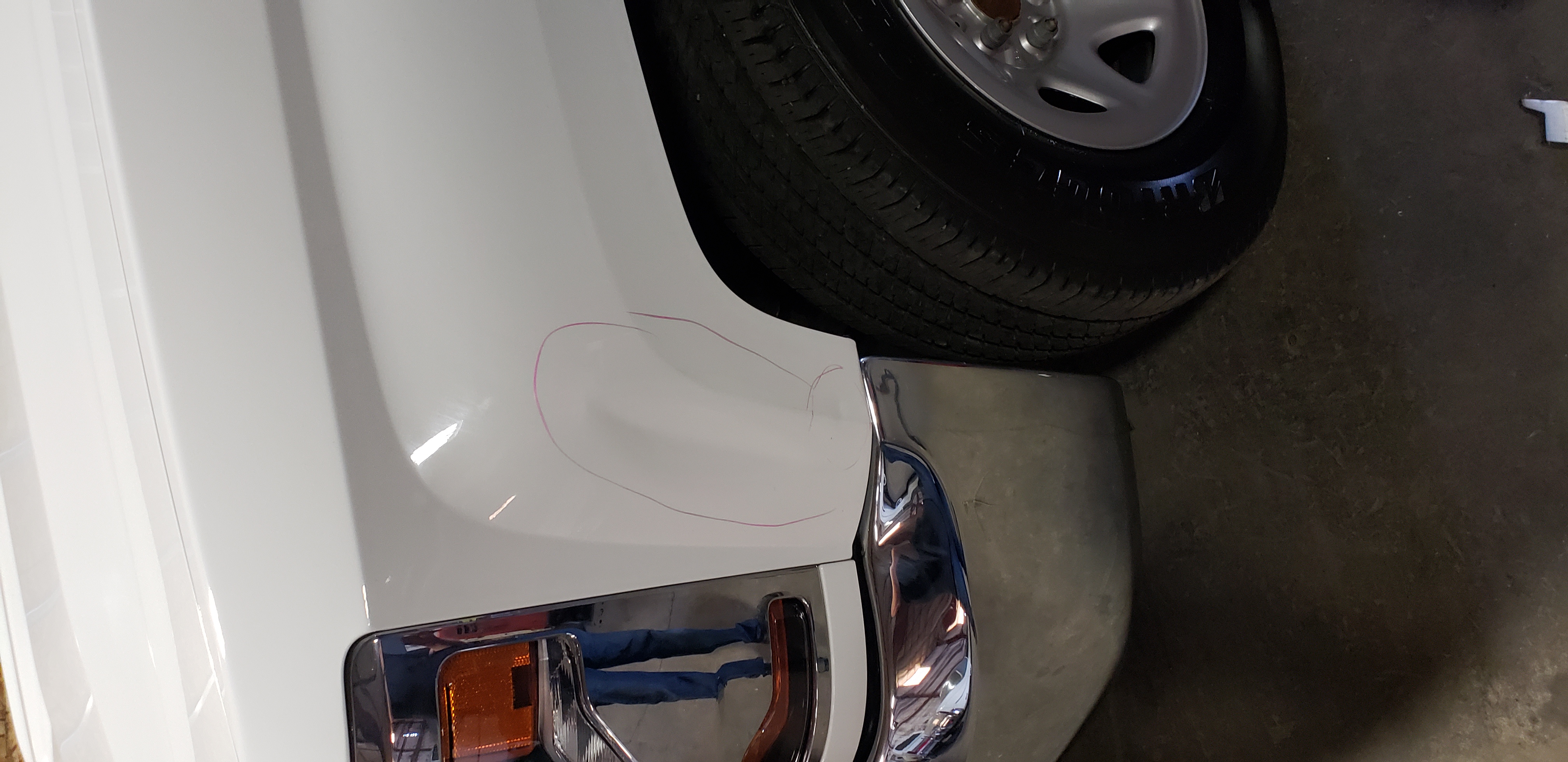 White front fender before paintless dent repair