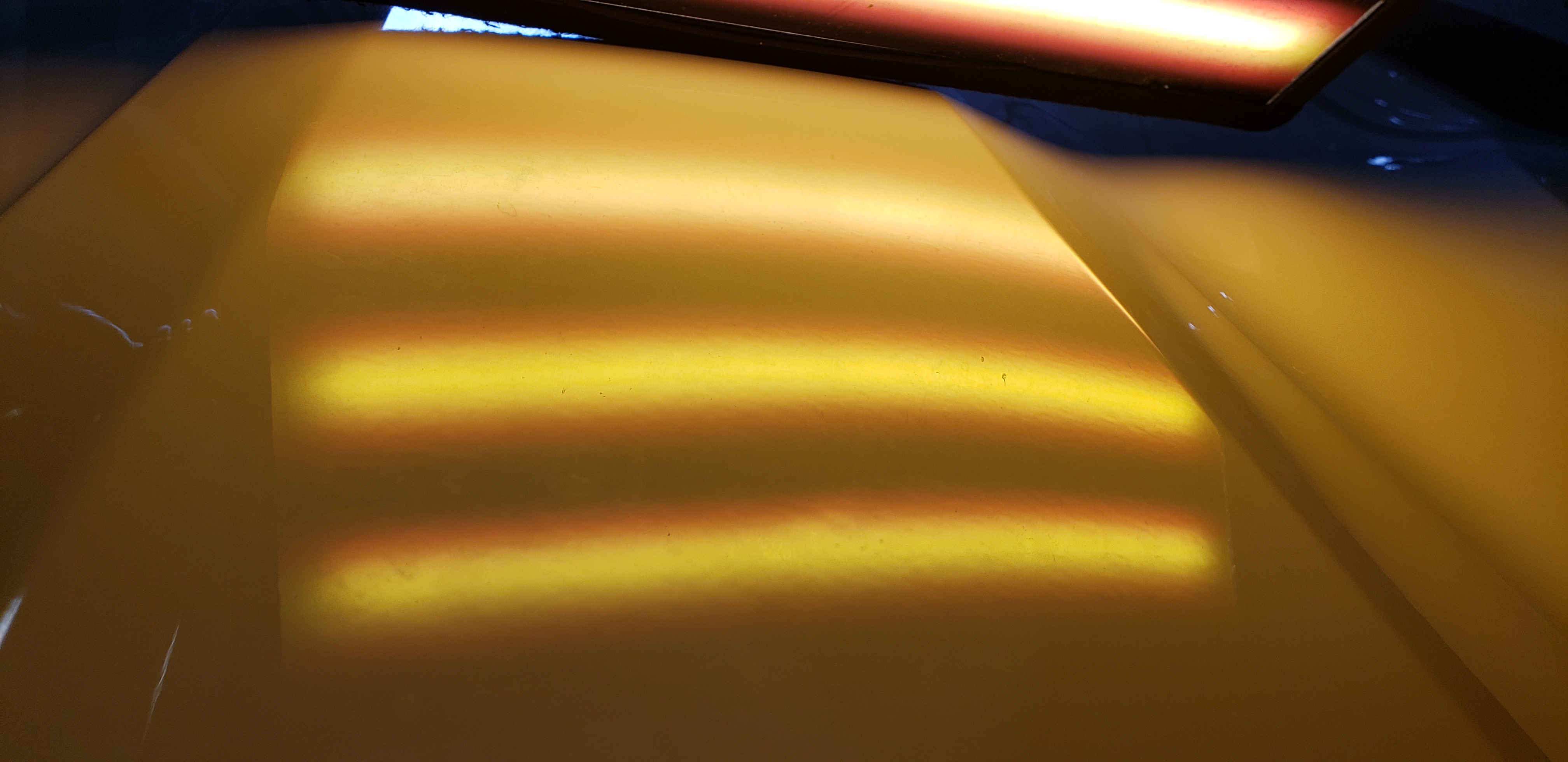 White truck quarter panel after paintless dent repair
