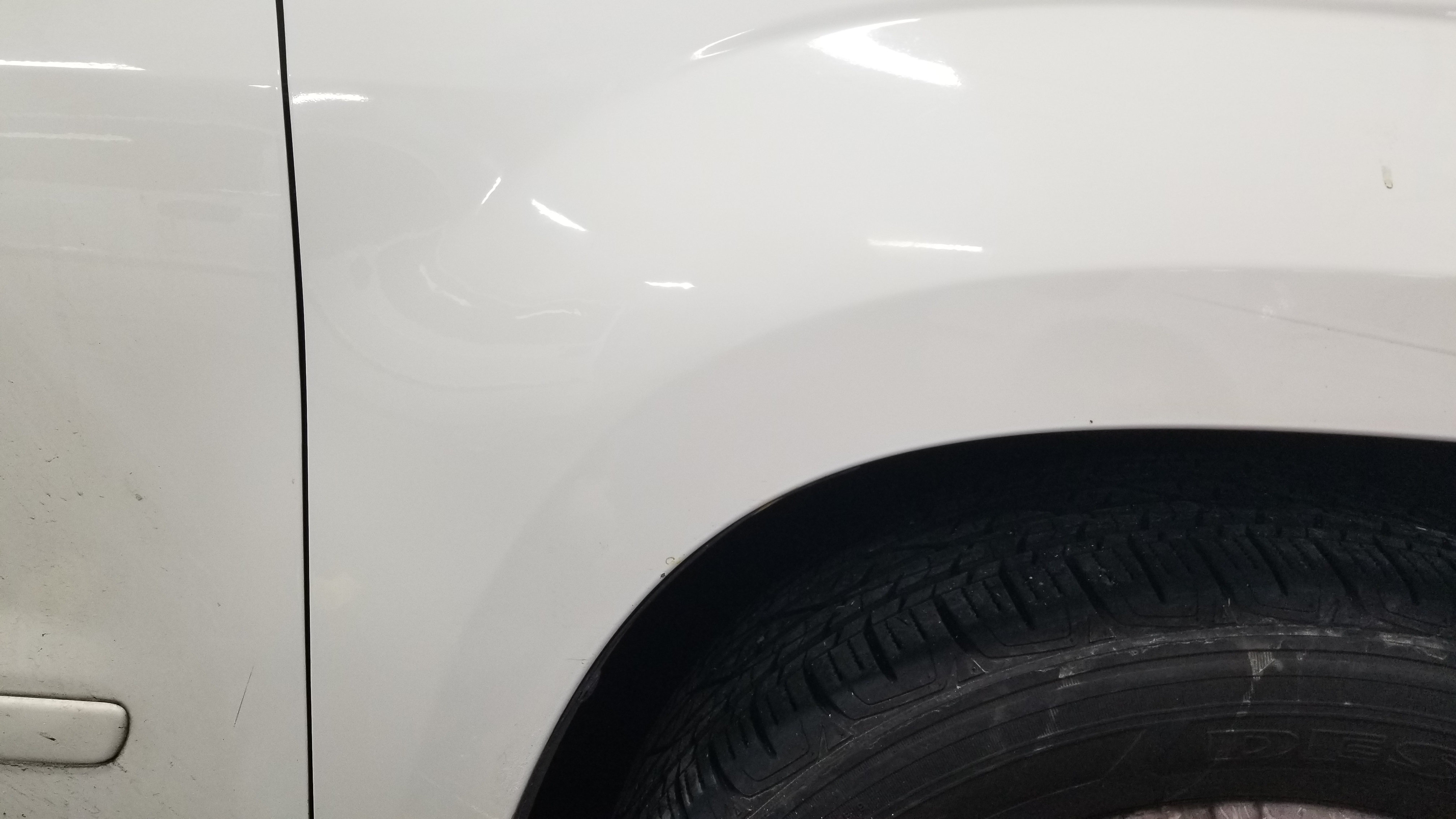 White wheel arch after paintless dent repair