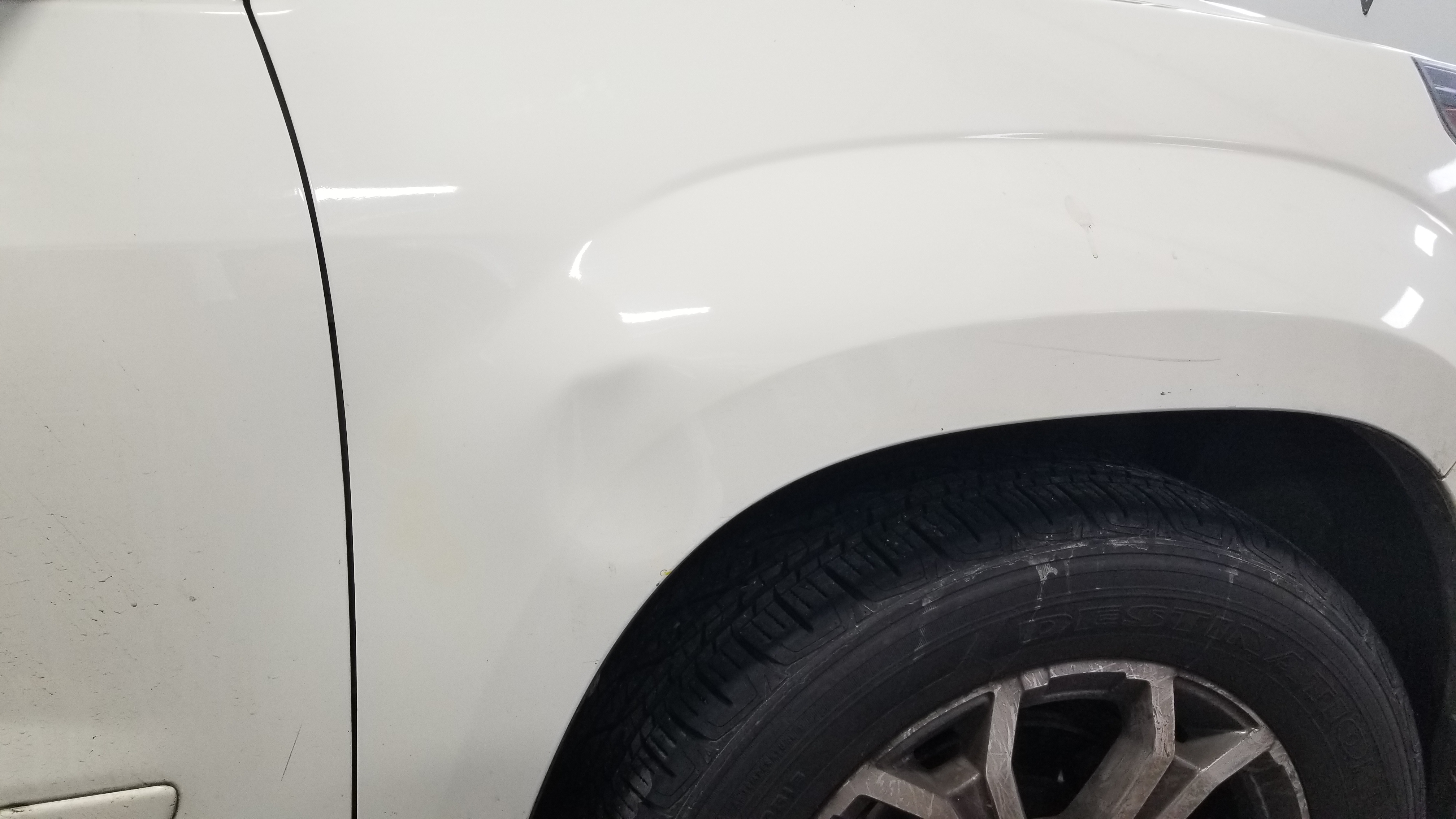 White wheel arch before paintless dent repair