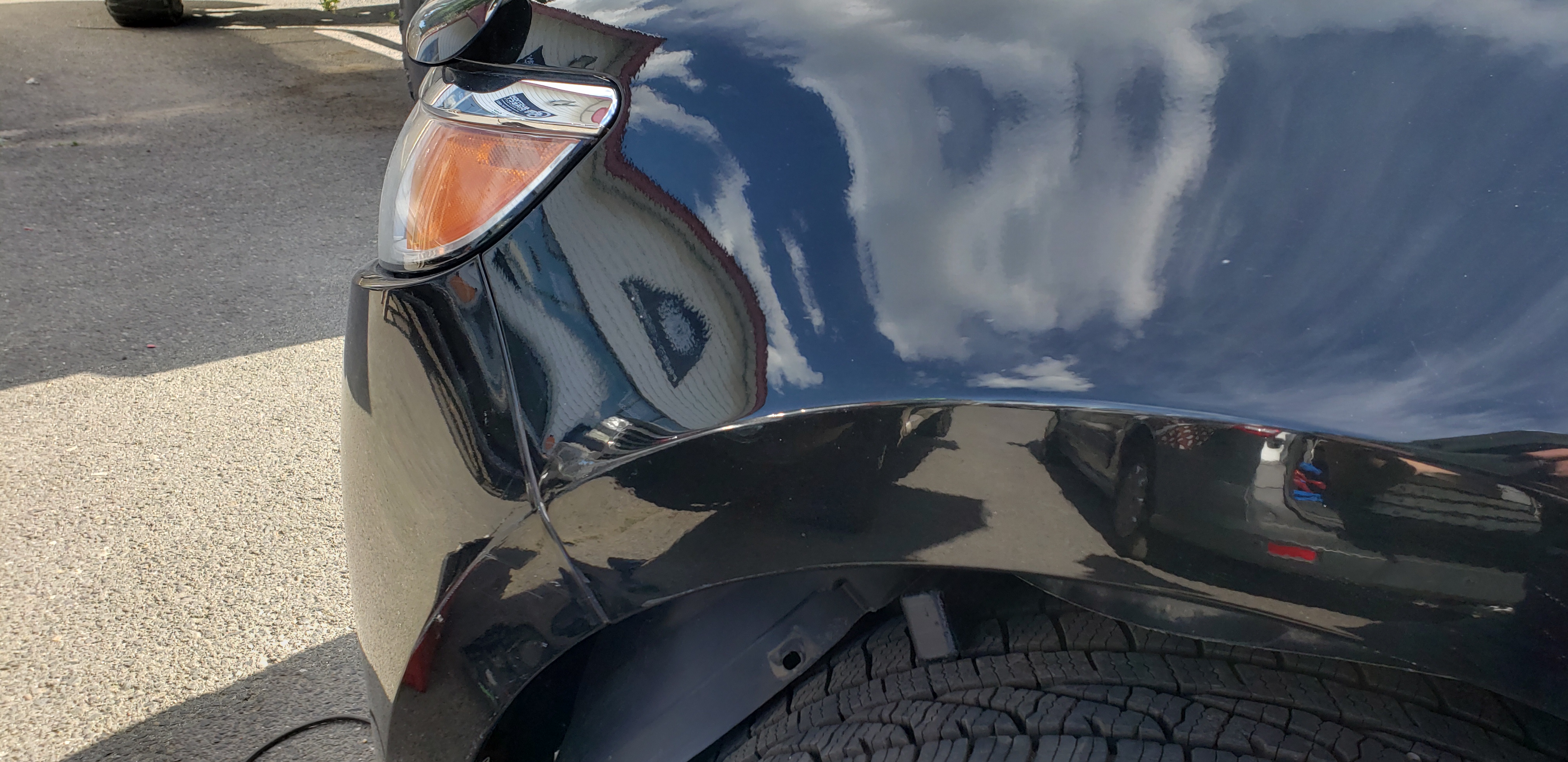 Dent shown with reflection board after paintless dent repair